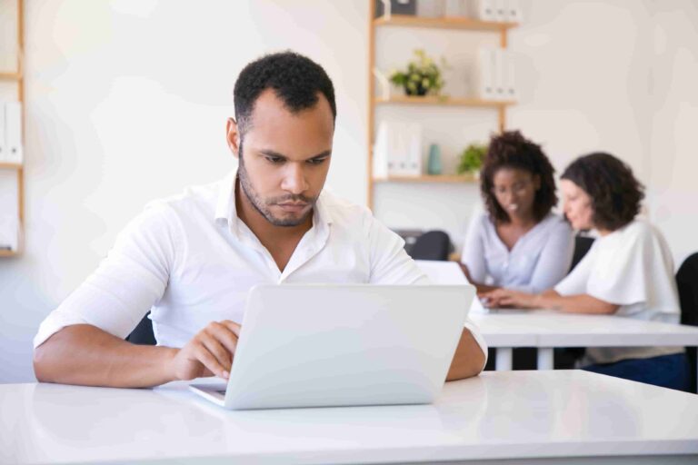 Fitness coach structuring email sequences on laptop to convert subscribers
