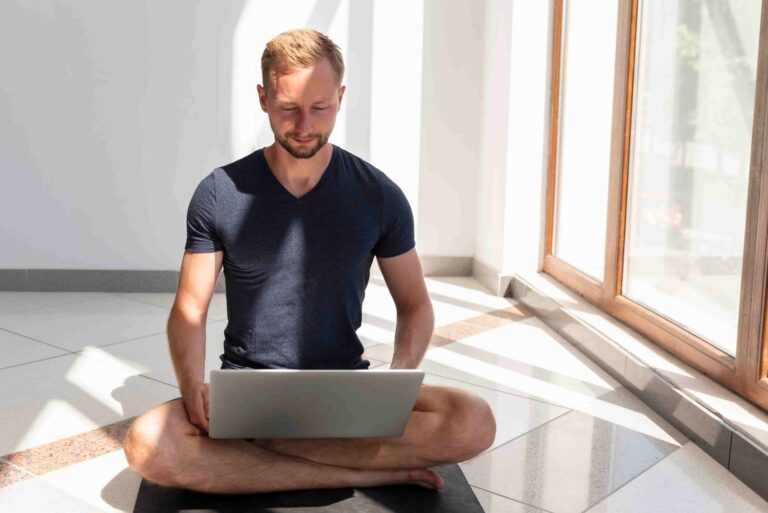 Online fitness coach writing effective content hooks on a laptop for social media videos