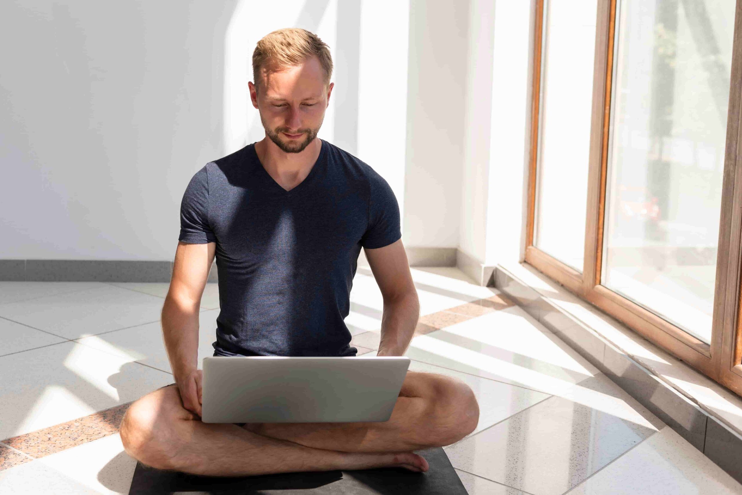 Online fitness coach writing effective content hooks on a laptop for social media videos