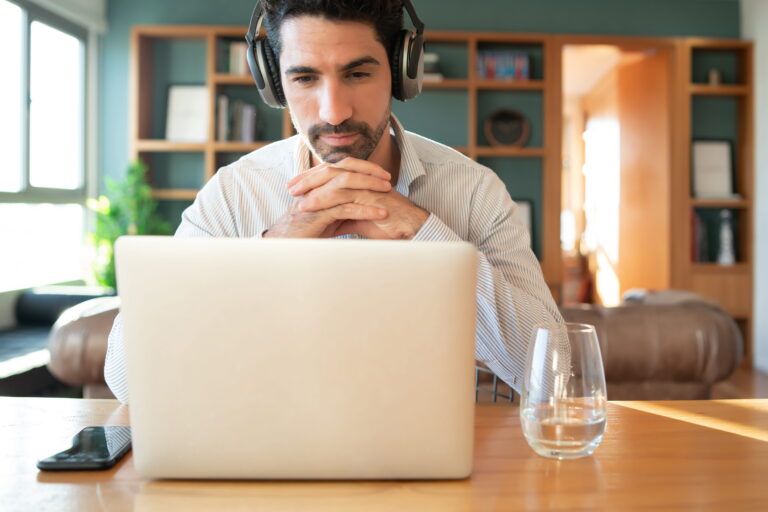 Online fitness coach writing welcome email to new subscribers on laptop