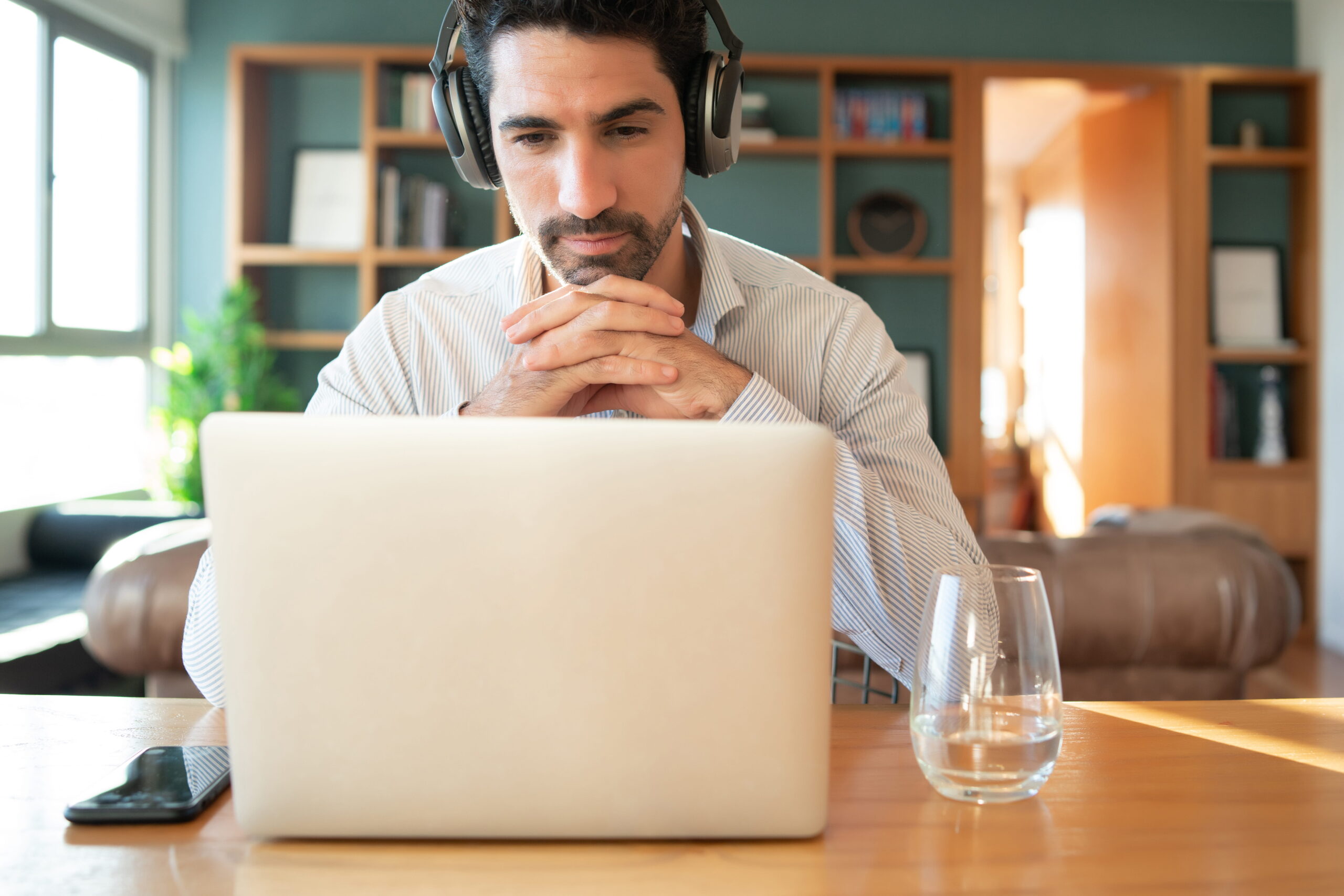 Online fitness coach writing welcome email to new subscribers on laptop