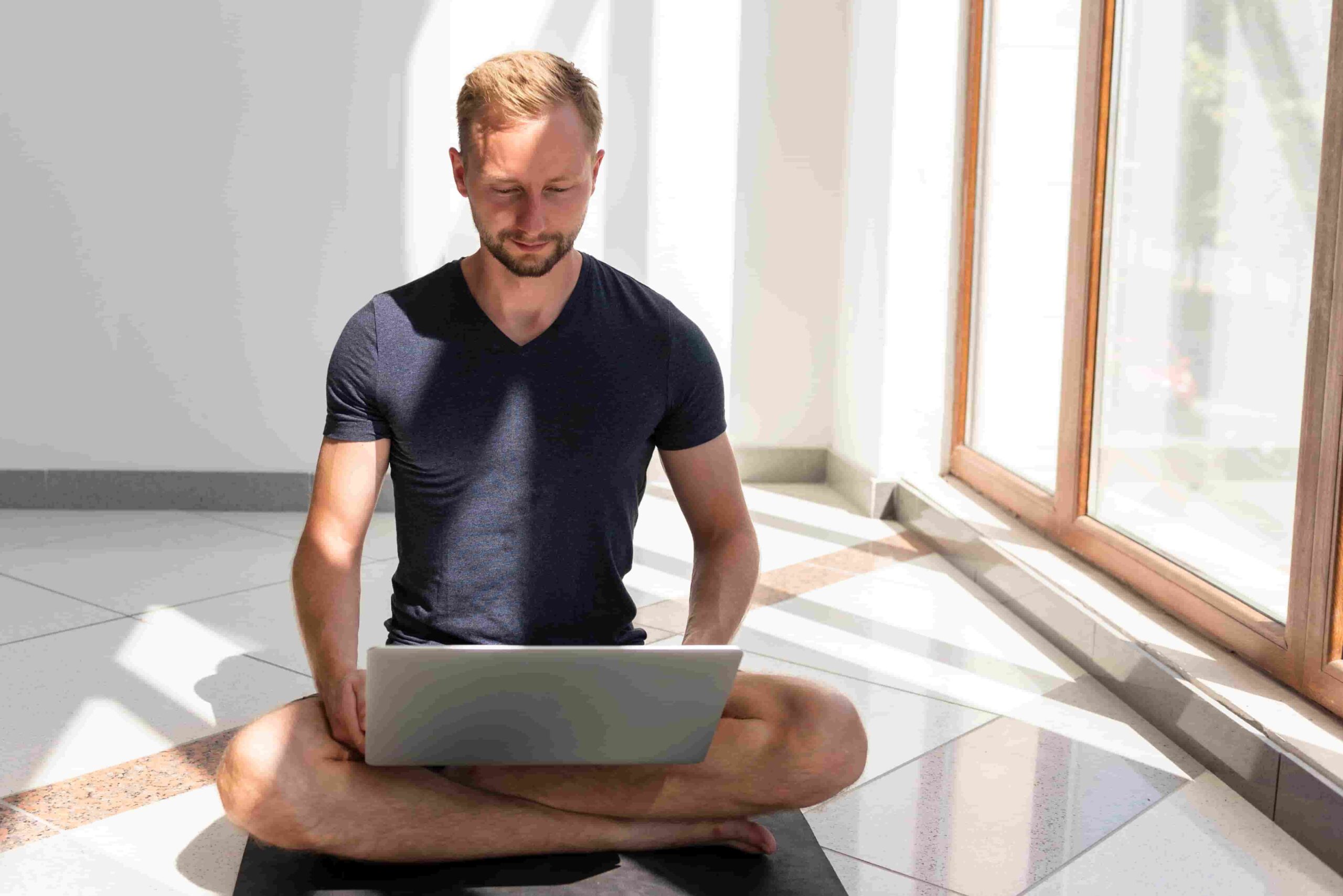 Online fitness coach checking email frequency metrics on laptop for optimal send schedule